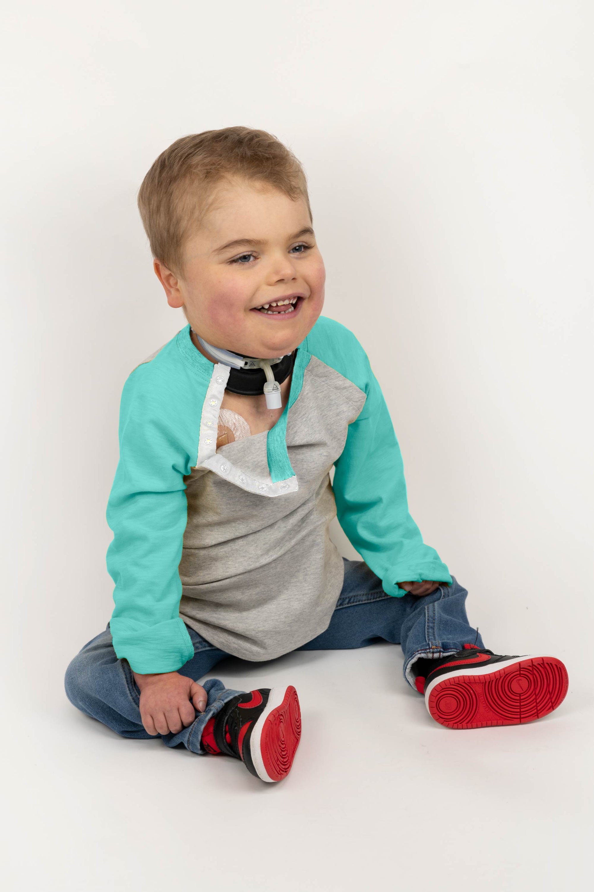 Boy in Kids Teal Raglan Access Tee with chest port