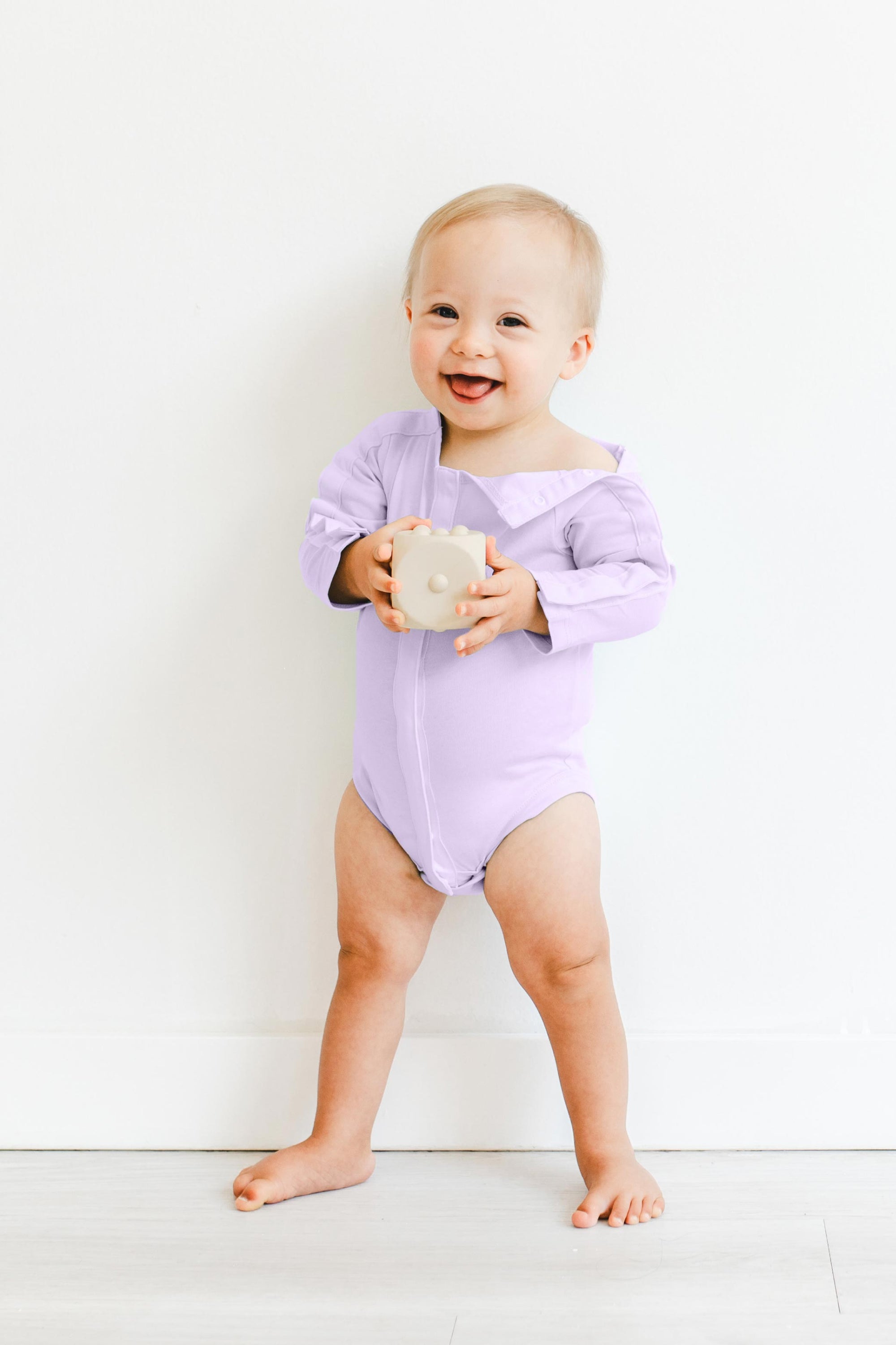 Boy wearing Lavender long sleeve all access bodysuit with snap open