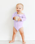 Boy wearing Lavender long sleeve all access bodysuit with snap open