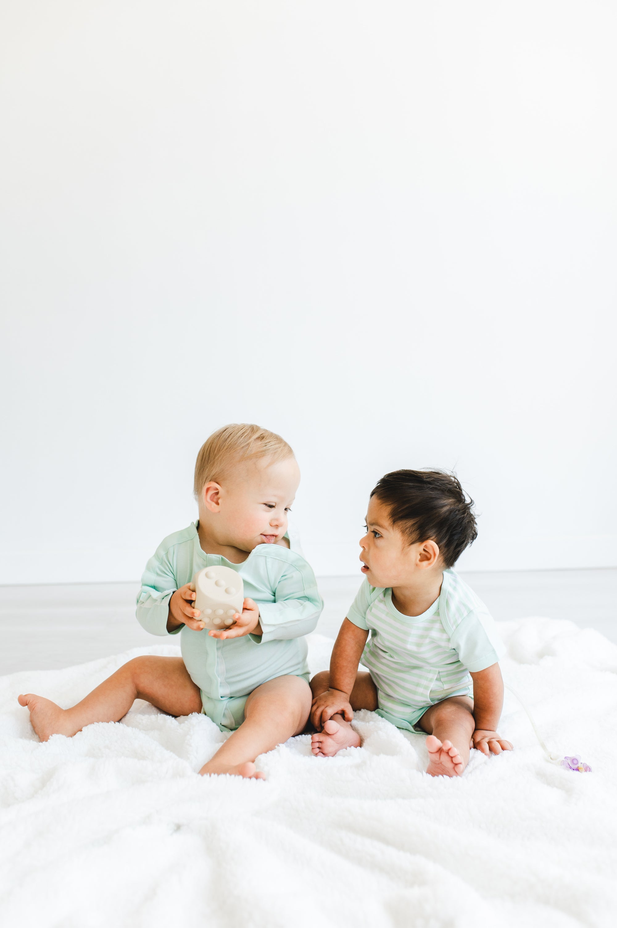 two boys wearing longsleeve all access bodysuit and side access g-tube bodysuit