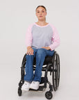 Woman in wheelchair wearing pink Adult Raglan Chemo Port Access Tee Shirt