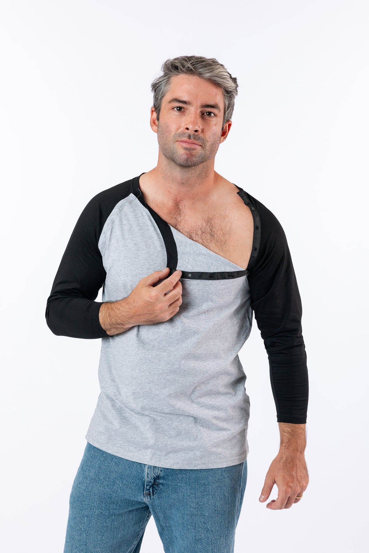 Male model unsnapping chest snaps on Black Raglan Access Tee