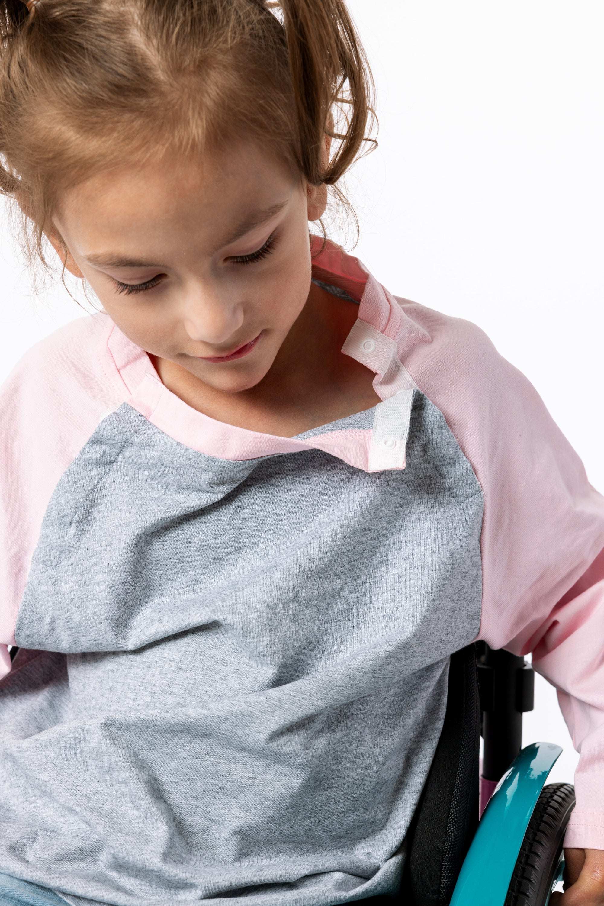 Gracie showing open snaps on Raglan Access Tee