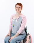 Female model in wheelchair posing with open chest snaps, showing chest port