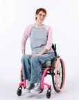Woman in wheelchair wearing pink Raglan Access Tee