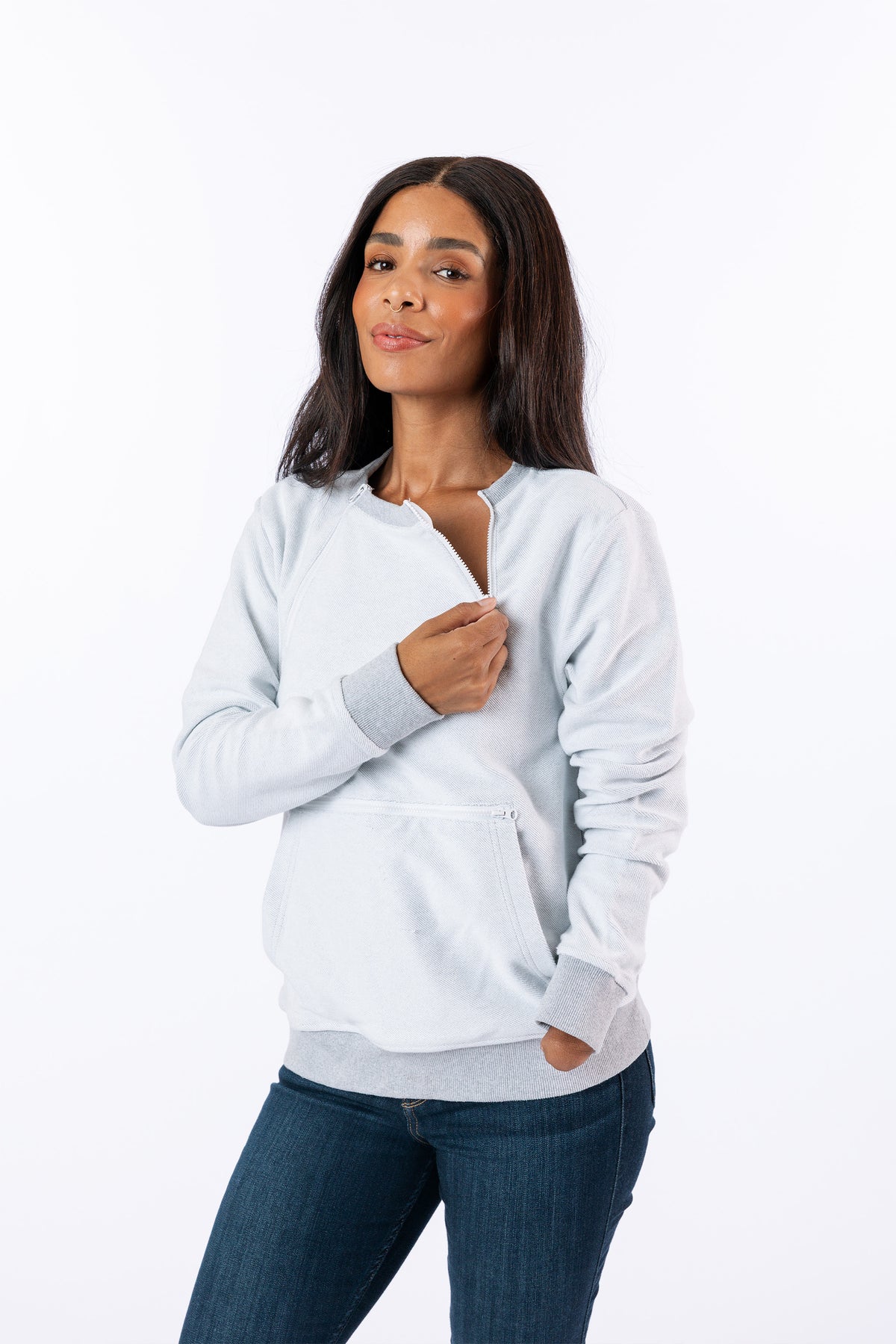 Celia wearing Reverse Triple Zip Crewneck Sweatshirt, unzipping one chest zipper