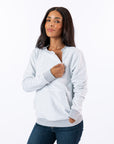 Celia wearing Reverse Triple Zip Crewneck Sweatshirt, unzipping one chest zipper