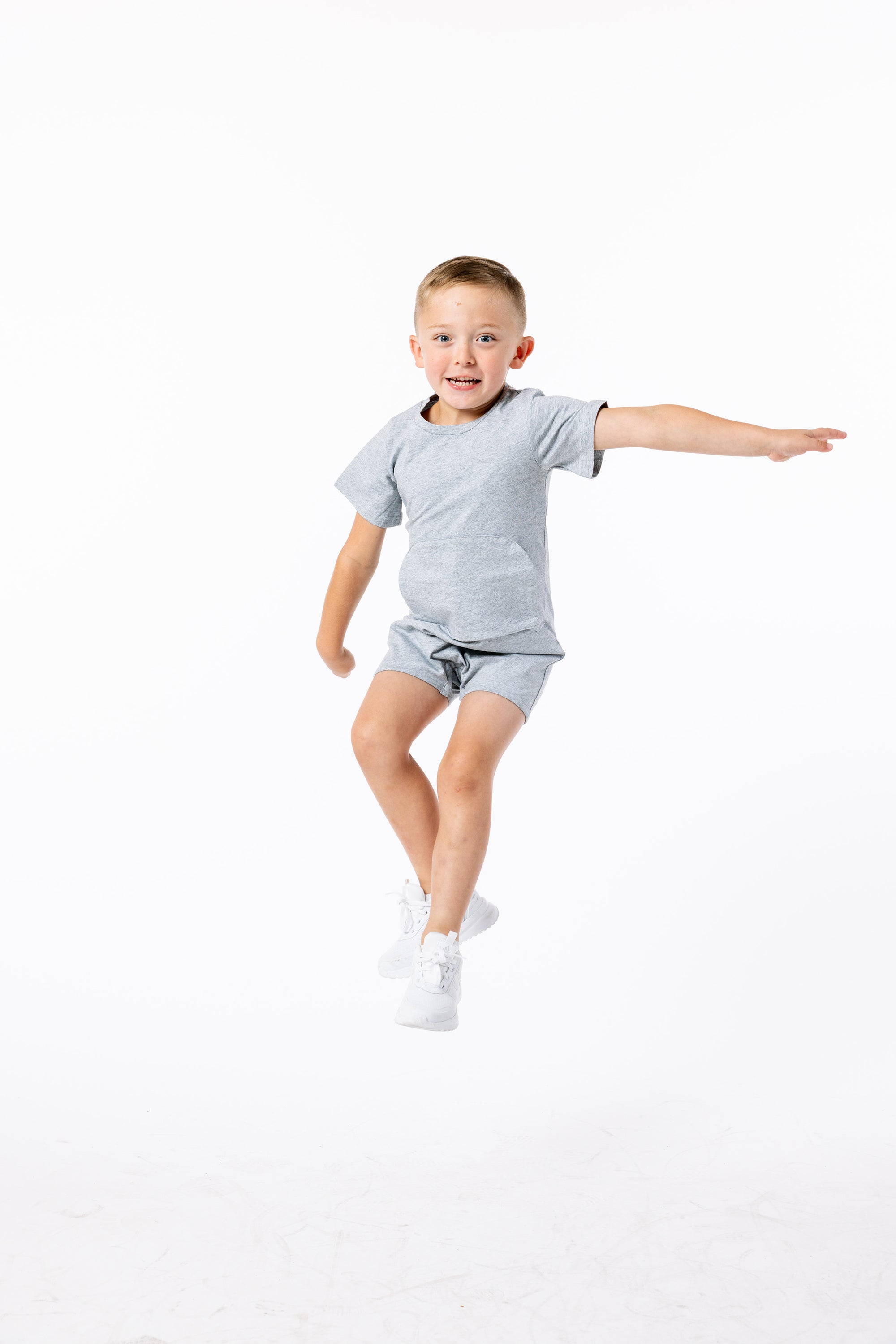 Finley posing in gray Tummy Access Bodysuit