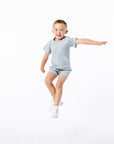 Finley posing in gray Tummy Access Bodysuit