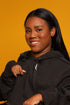 Model wearing black zipper access hoodie with front zipper open
