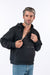 Male model wearing black Zipper Access Hoodie, unzipping one chest zipper for chest port access