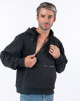 Male model wearing black Zipper Access Hoodie, unzipping one chest zipper for chest port access