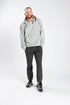 Model wearing gray adaptive hoodie with hands in pockets