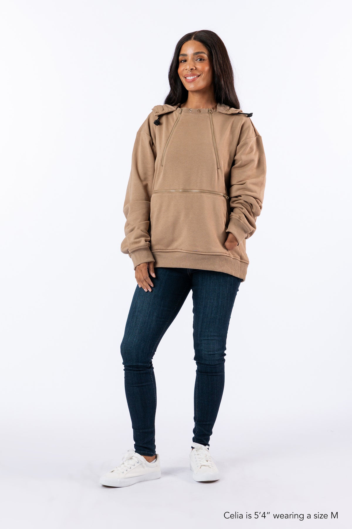 Woman wearing Khaki Zipper Access Hoodie. Text reads "Celia is 5'4" wearing a size M".