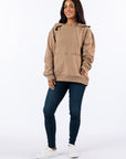 Woman wearing Khaki Zipper Access Hoodie. Text reads "Celia is 5'4" wearing a size M".
