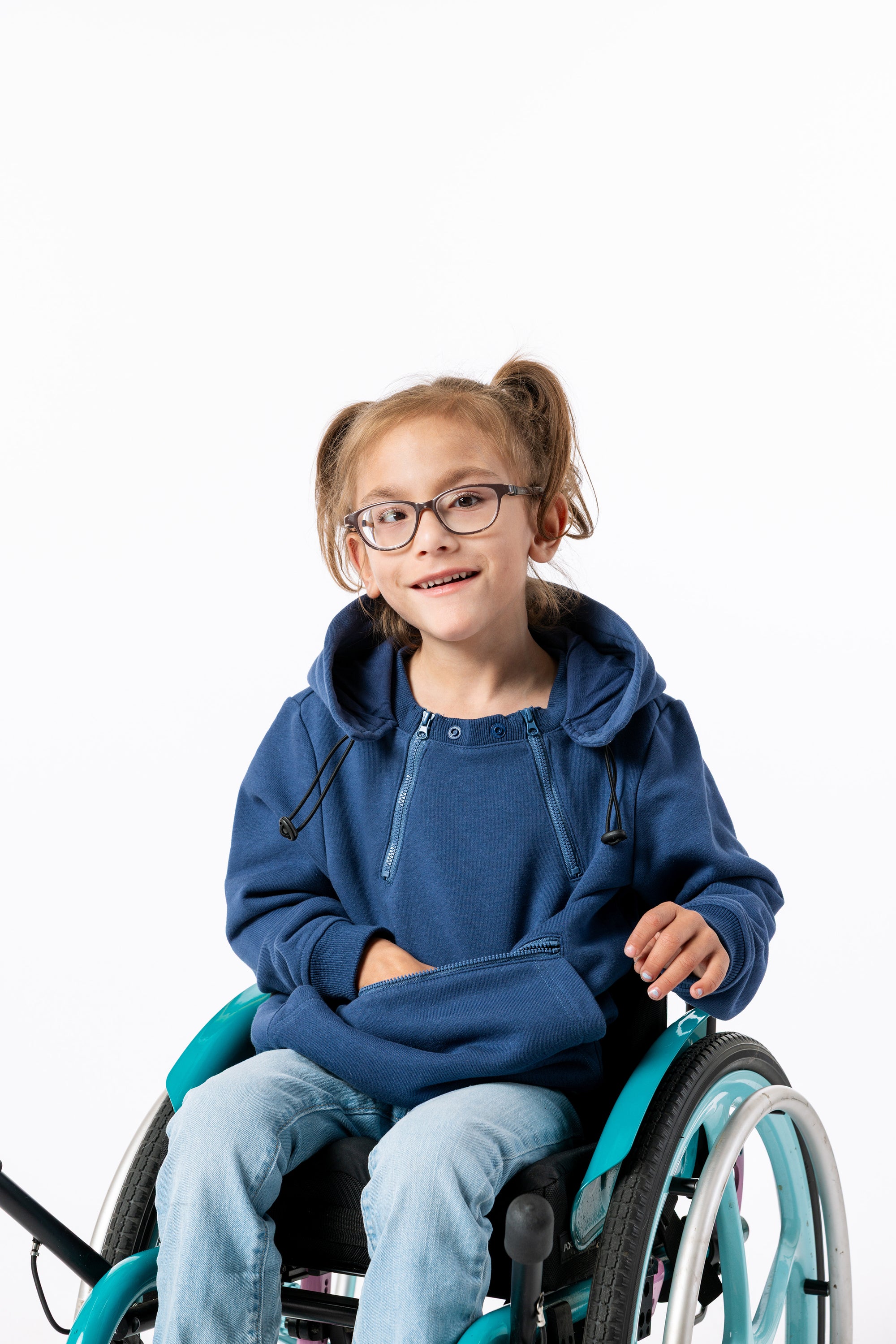 Young girl in a wheelchair wearing a blue Zipper Access hoodie on a white background