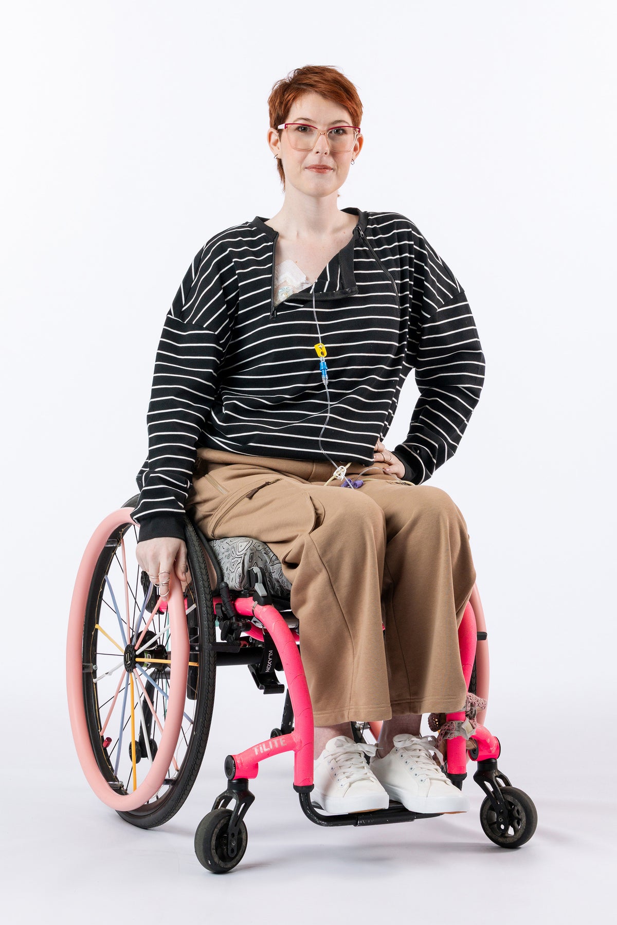Woman in wheelchair with open chest zipper