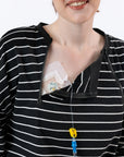 Closeup of woman with chest port. Open chest zipper allows tubing to come through zipper