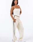 Female model wearing Vanilla Zipper Access Pants. Text reads "Celia is 5'4" wearing a size XS".