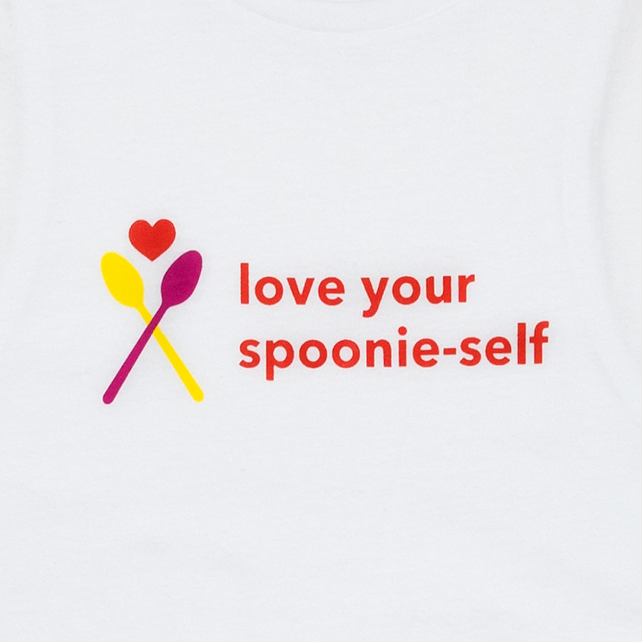 White Women’s Crop tee with “Love your Spoonie Self” text graphic closeup