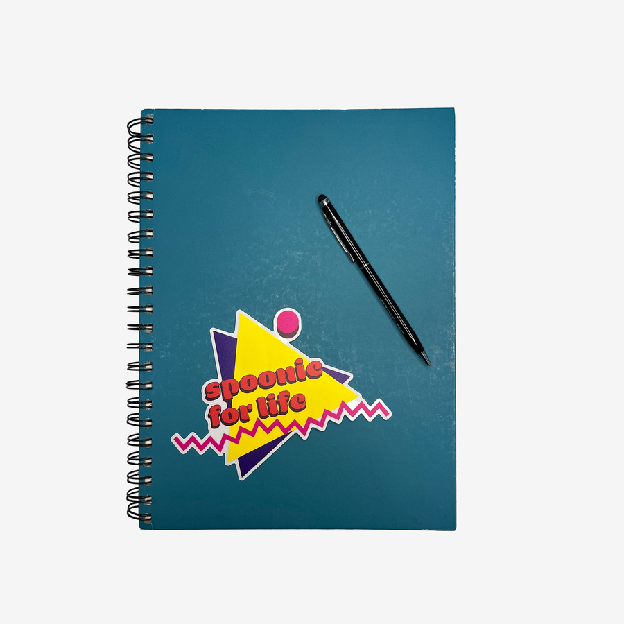 Yellow purple and pink Spoonie For Life sticker on spiral notebook